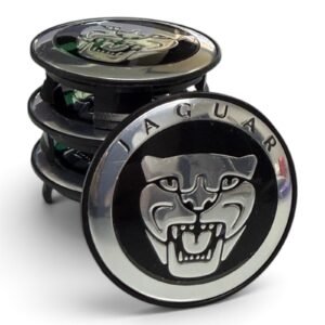 Set of 4 black Jaguar wheel center caps with chrome Jaguar face on a white background